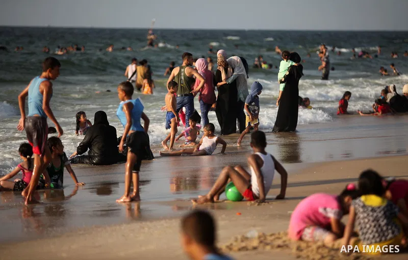 Palestinian children enjoy a day at the beach in Deir Al Balah in the center of Gaza strip at the last Friday of summer holiday, on Aug. 26, 2016. Photo by Ashraf Amra