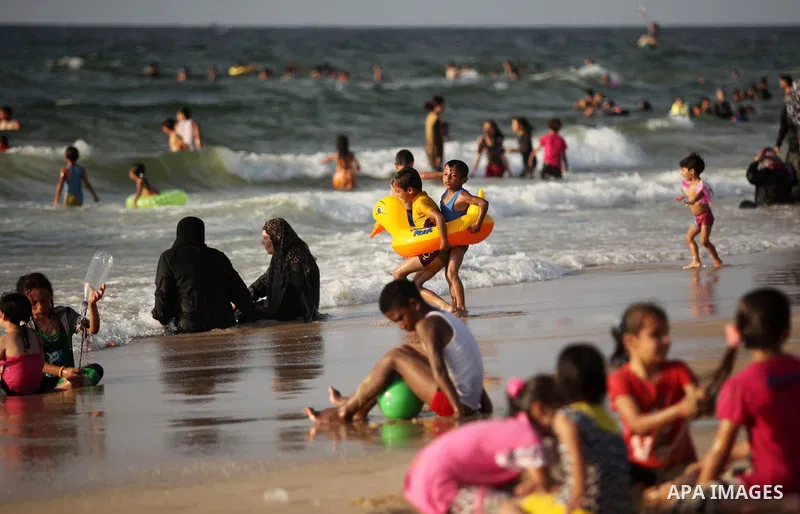 Palestinian children enjoy a day at the beach in Deir Al Balah in the center of Gaza strip at the last Friday of summer holiday, on Aug. 26, 2016. Photo by Ashraf Amra
