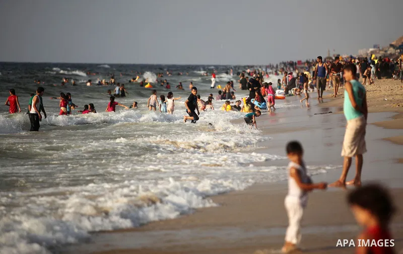 Palestinian children enjoy a day at the beach in Deir Al Balah in the center of Gaza strip at the last Friday of summer holiday, on Aug. 26, 2016. Photo by Ashraf Amra
