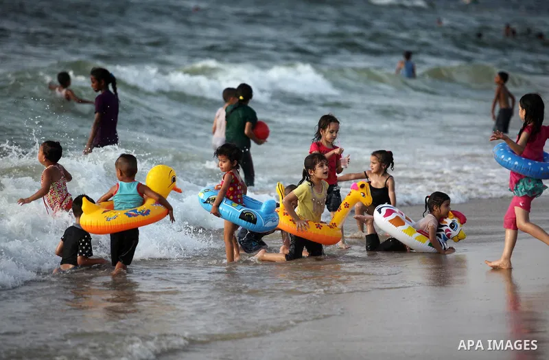 Palestinian children enjoy a day at the beach in Deir Al Balah in the center of Gaza strip at the last Friday of summer holiday, on Aug. 26, 2016. Photo by Ashraf Amra