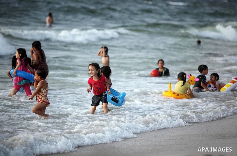 Palestinian children enjoy a day at the beach in Deir Al Balah in the center of Gaza strip at the last Friday of summer holiday, on Aug. 26, 2016. Photo by Ashraf Amra
