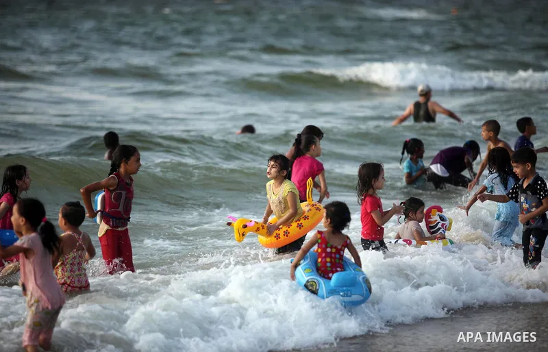 Palestinian children enjoy a day at the beach in Deir Al Balah in the center of Gaza strip at the last Friday of summer holiday, on Aug. 26, 2016. Photo by Ashraf Amra