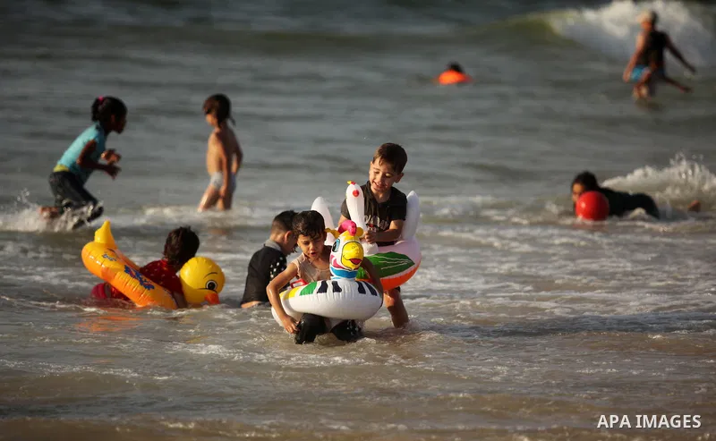 Palestinian children enjoy a day at the beach in Deir Al Balah in the center of Gaza strip at the last Friday of summer holiday, on Aug. 26, 2016. Photo by Ashraf Amra