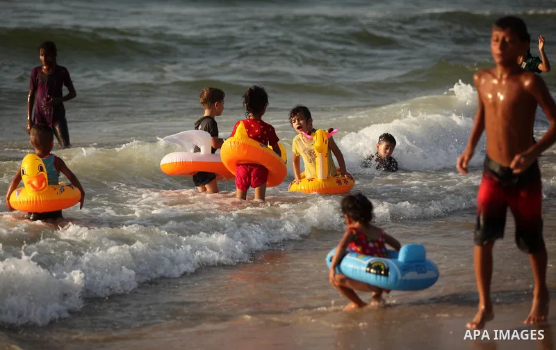 Palestinian children enjoy a day at the beach in Deir Al Balah in the center of Gaza strip at the last Friday of summer holiday, on Aug. 26, 2016. Photo by Ashraf Amra