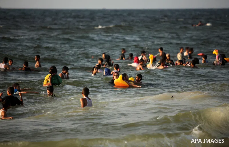 Palestinian children enjoy a day at the beach in Deir Al Balah in the center of Gaza strip at the last Friday of summer holiday, on Aug. 26, 2016. Photo by Ashraf Amra
