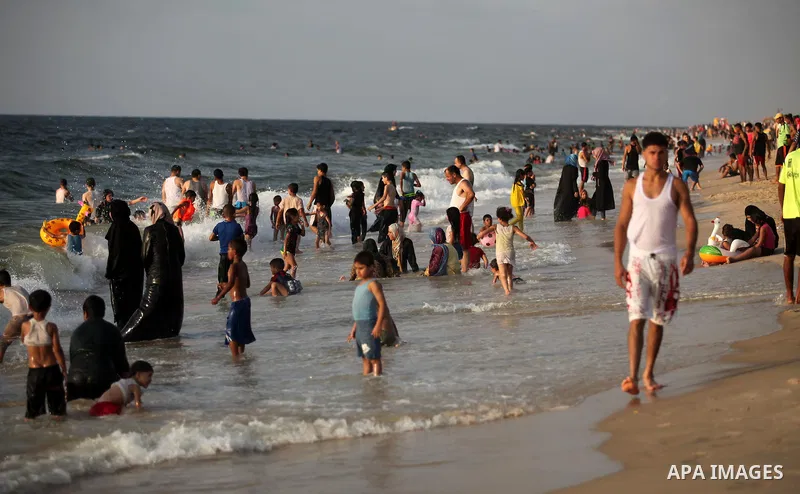 Palestinian children enjoy a day at the beach in Deir Al Balah in the center of Gaza strip at the last Friday of summer holiday, on Aug. 26, 2016. Photo by Ashraf Amra