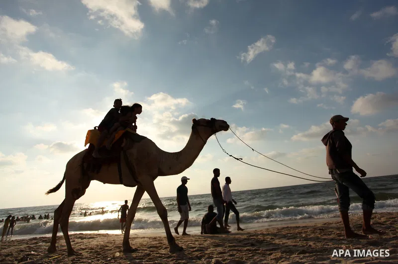Palestinian children enjoy a day at the beach in Deir Al Balah in the center of Gaza strip at the last Friday of summer holiday, on Aug. 26, 2016. Photo by Ashraf Amra