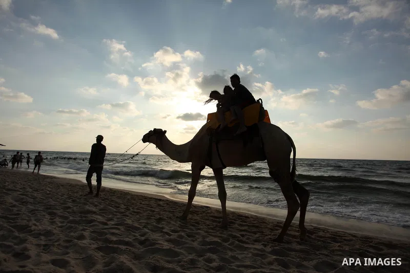 Palestinian children enjoy a day at the beach in Deir Al Balah in the center of Gaza strip at the last Friday of summer holiday, on Aug. 26, 2016. Photo by Ashraf Amra