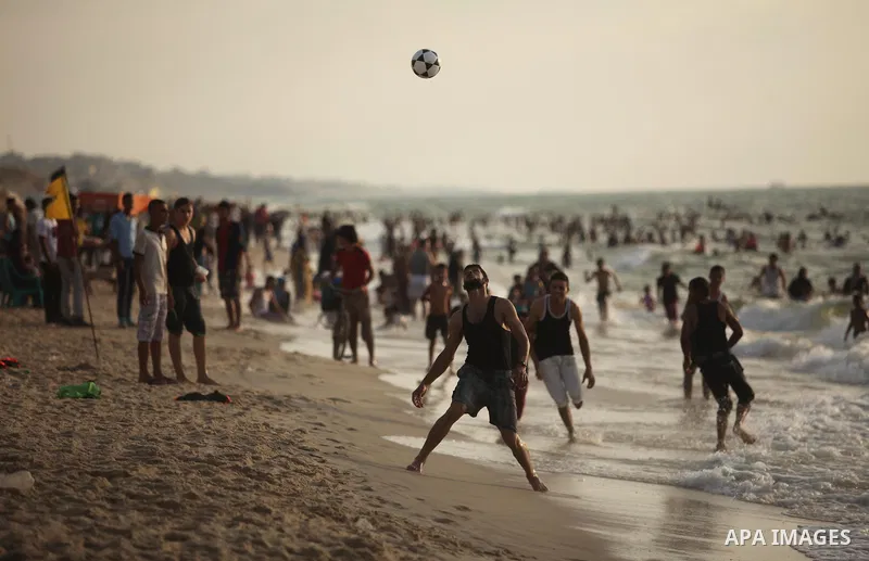 Palestinian children enjoy a day at the beach in Deir Al Balah in the center of Gaza strip at the last Friday of summer holiday, on Aug. 26, 2016. Photo by Ashraf Amra