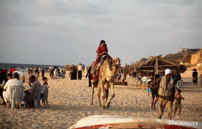 Palestinian children enjoy a day at the beach in Deir Al Balah in the center of Gaza strip at the last Friday of summer holiday, on Aug. 26, 2016. Photo by Ashraf Amra