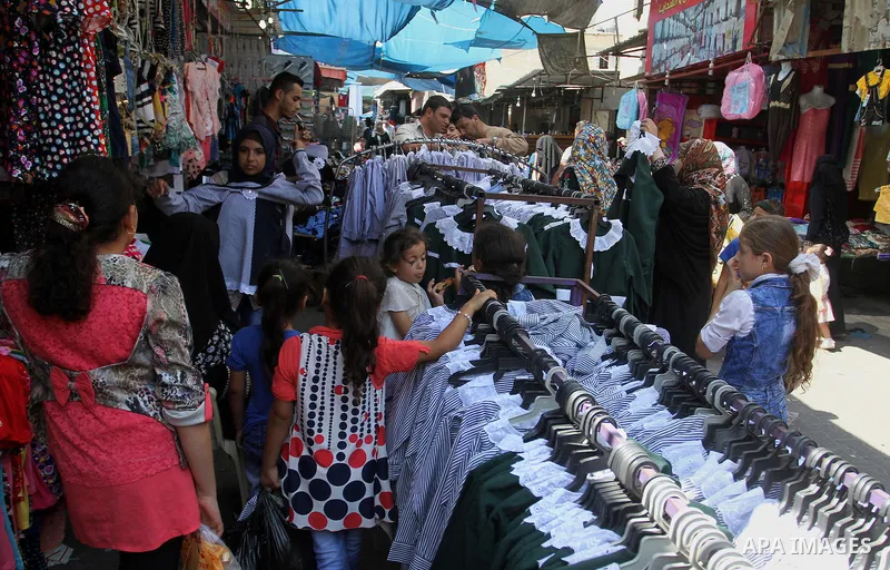 Palestinians shop during preparation for the new school year at a market in Rafah in the southern Gaza strip on August 27, 2016. Photo by Abed Rahim Khatib