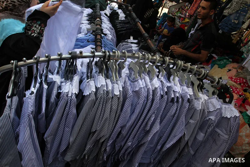 Palestinians shop during preparation for the new school year at a market in Rafah in the southern Gaza strip on August 27, 2016. Photo by Abed Rahim Khatib