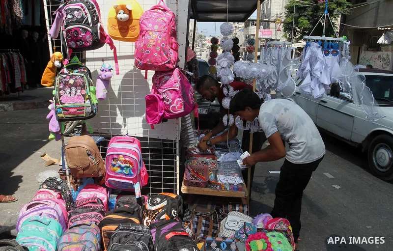 Palestinians shop during preparation for the new school year at a market in Rafah in the southern Gaza strip on August 27, 2016. Photo by Abed Rahim Khatib