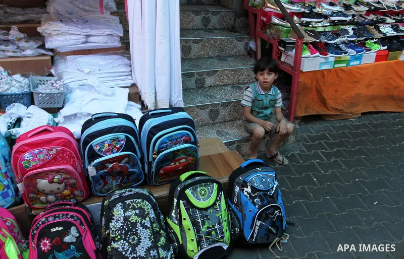 Palestinians shop during preparation for the new school year at a market in Rafah in the southern Gaza strip on August 27, 2016. Photo by Abed Rahim Khatib