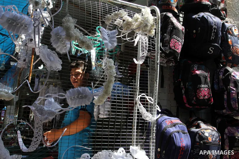 Palestinians shop during preparation for the new school year at a market in Rafah in the southern Gaza strip on August 27, 2016. Photo by Abed Rahim Khatib