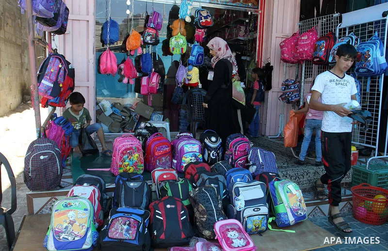 Palestinians shop during preparation for the new school year at a market in Rafah in the southern Gaza strip on August 27, 2016. Photo by Abed Rahim Khatib