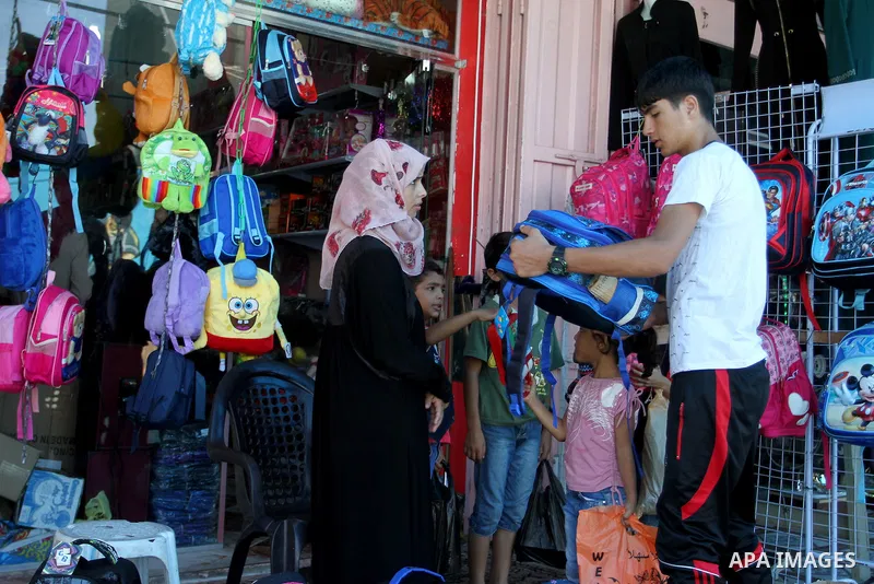 Palestinians shop during preparation for the new school year at a market in Rafah in the southern Gaza strip on August 27, 2016. Photo by Abed Rahim Khatib