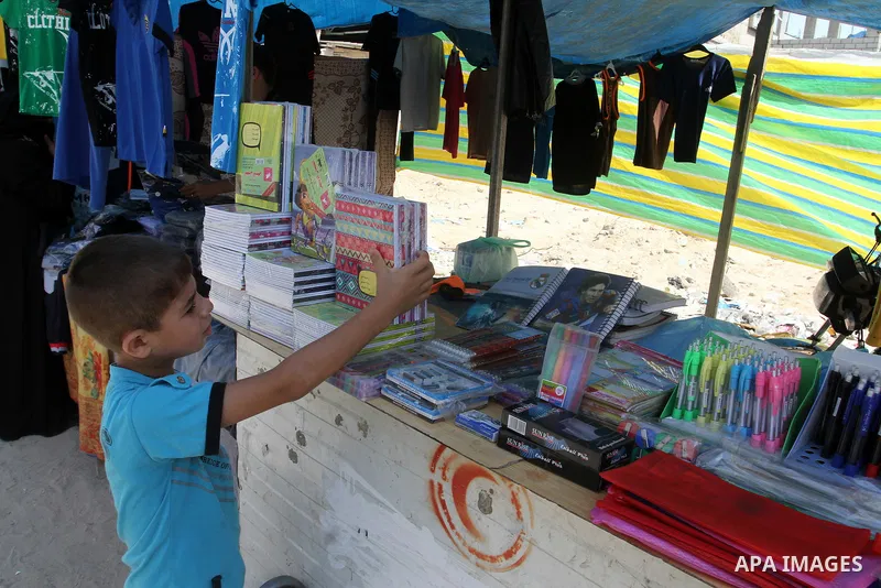 Palestinians shop during preparation for the new school year at a market in Rafah in the southern Gaza strip on August 27, 2016. Photo by Abed Rahim Khatib