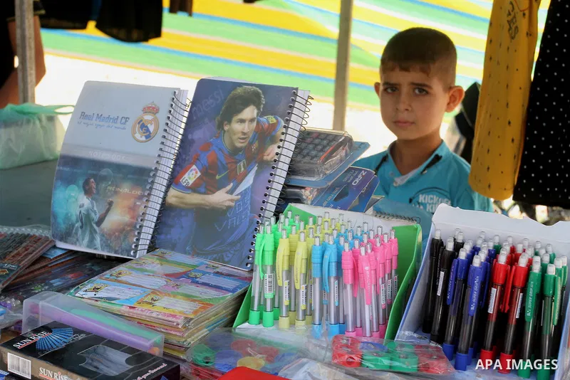 Palestinians shop during preparation for the new school year at a market in Rafah in the southern Gaza strip on August 27, 2016. Photo by Abed Rahim Khatib