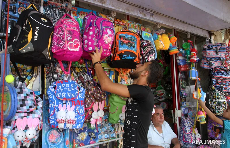 Palestinians shop during preparation for the new school year at a market in Rafah in the southern Gaza strip on August 27, 2016. Photo by Abed Rahim Khatib