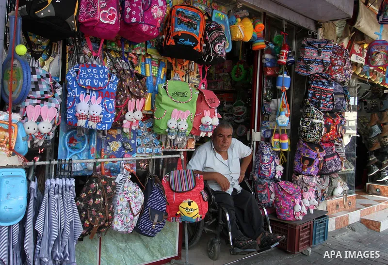 Palestinians shop during preparation for the new school year at a market in Rafah in the southern Gaza strip on August 27, 2016. Photo by Abed Rahim Khatib