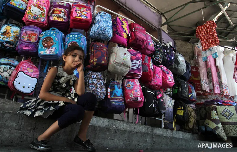 Palestinians shop during preparation for the new school year at a market in Rafah in the southern Gaza strip on August 27, 2016. Photo by Abed Rahim Khatib