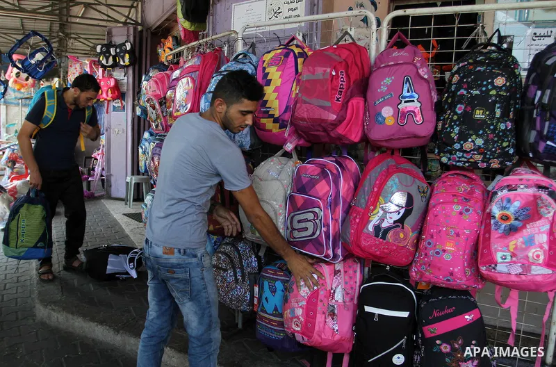 Palestinians shop during preparation for the new school year at a market in Rafah in the southern Gaza strip on August 27, 2016. Photo by Abed Rahim Khatib