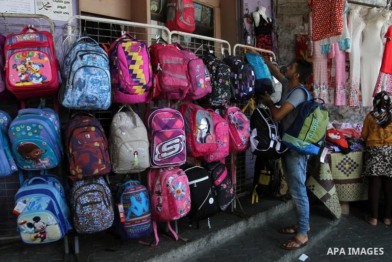 Palestinians shop during preparation for the new school year at a market in Rafah in the southern Gaza strip on August 27, 2016. Photo by Abed Rahim Khatib