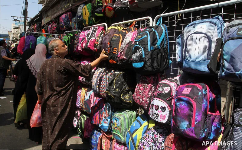 Palestinians shop during preparation for the new school year at a market in Rafah in the southern Gaza strip on August 27, 2016. Photo by Abed Rahim Khatib