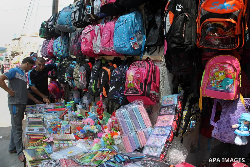 Palestinians shop during preparation for the new school year at a market in Rafah in the southern Gaza strip on August 27, 2016. Photo by Abed Rahim Khatib