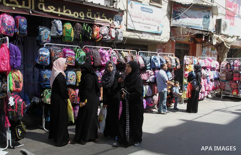 Palestinians shop during preparation for the new school year at a market in Rafah in the southern Gaza strip on August 27, 2016. Photo by Abed Rahim Khatib