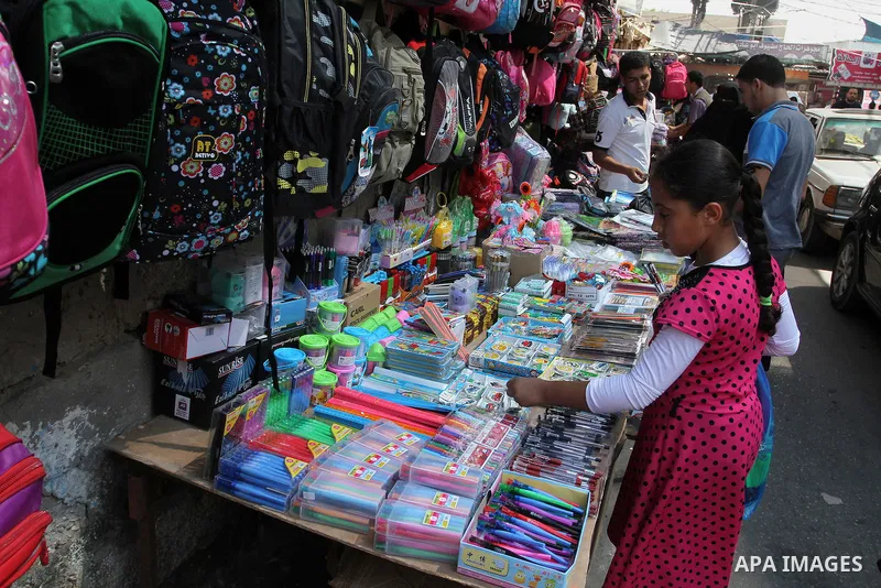 Palestinians shop during preparation for the new school year at a market in Rafah in the southern Gaza strip on August 27, 2016. Photo by Abed Rahim Khatib