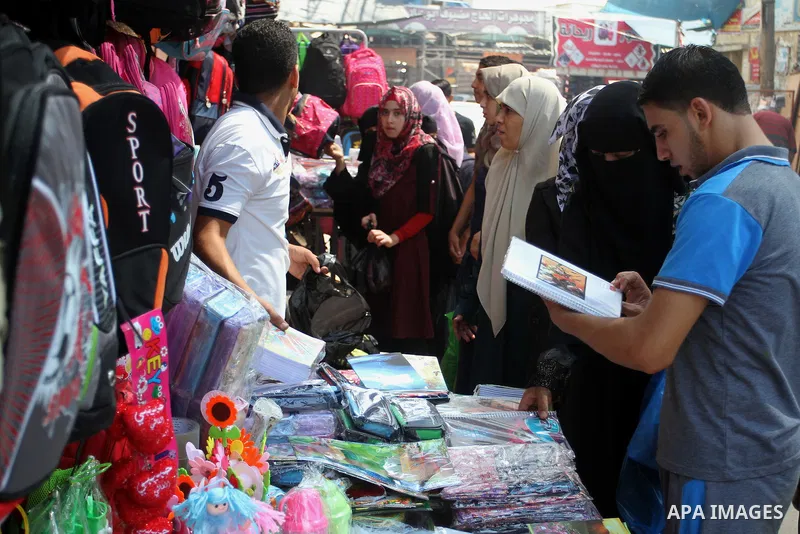 Palestinians shop during preparation for the new school year at a market in Rafah in the southern Gaza strip on August 27, 2016. Photo by Abed Rahim Khatib