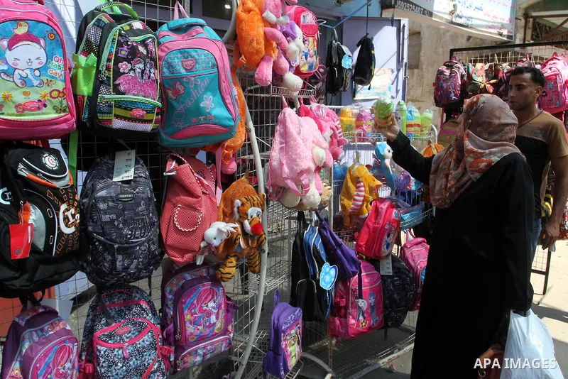 Palestinians shop during preparation for the new school year at a market in Rafah in the southern Gaza strip on August 27, 2016. Photo by Abed Rahim Khatib