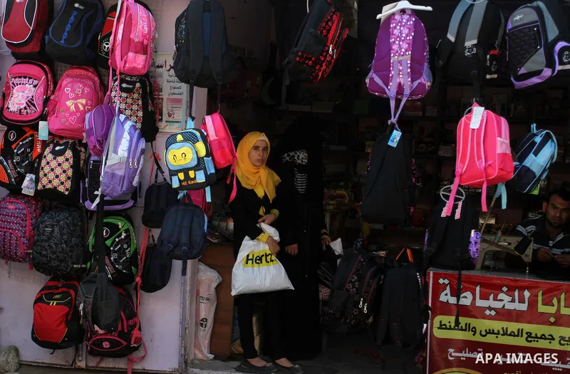 Palestinians shop during preparation for the new school year at a market in Rafah in the southern Gaza strip on August 27, 2016. Photo by Abed Rahim Khatib