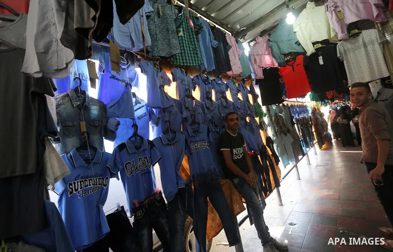 Palestinians shop during preparation for the new school year at a market in Gaza city, on August 27, 2016. Photo by Mohammed Asad