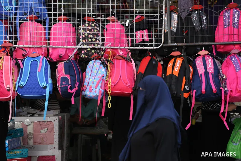 Palestinians shop during preparation for the new school year at a market in Gaza city, on August 27, 2016. Photo by Mohammed Asad
