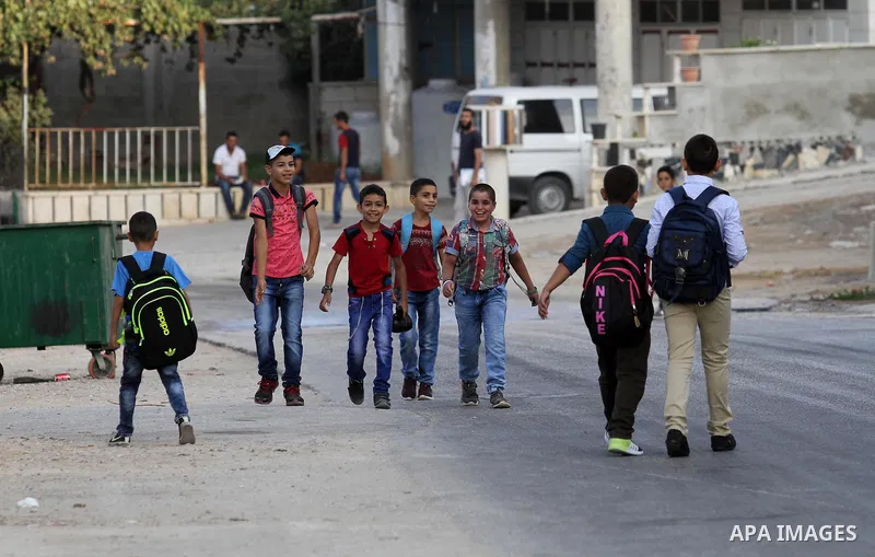 Palestinian students return back to their school in the morning of the first day of the new year study, in the West Bank city of Nablus, on August 28, 2016. Photo by Nedal Eshtayah