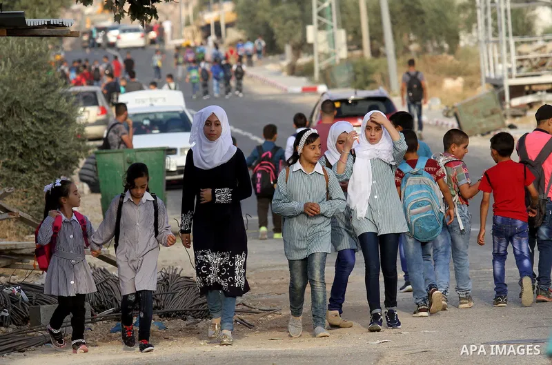 Palestinian students return back to their school in the morning of the first day of the new year study, in the West Bank city of Nablus, on August 28, 2016. Photo by Nedal Eshtayah