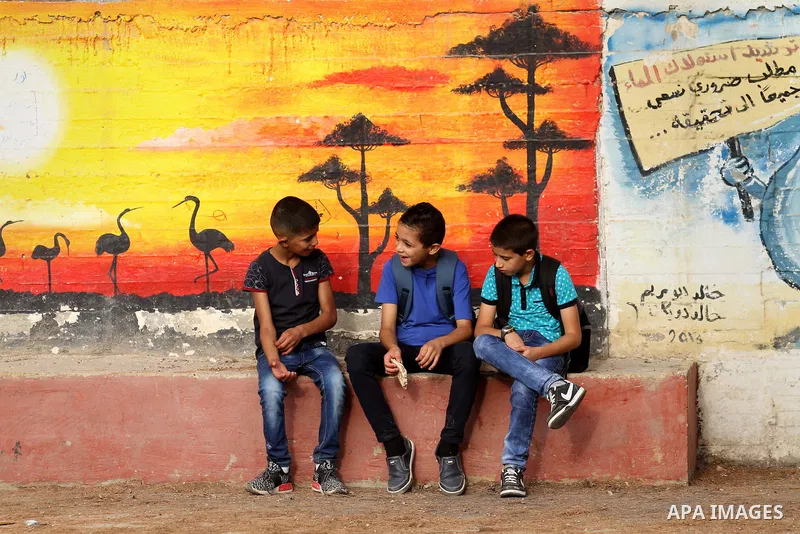 Palestinian students return back to their school in the morning of the first day of the new year study, in the West Bank city of Nablus, on August 28, 2016. Photo by Nedal Eshtayah