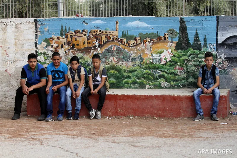 Palestinian students return back to their school in the morning of the first day of the new year study, in the West Bank city of Nablus, on August 28, 2016. Photo by Nedal Eshtayah