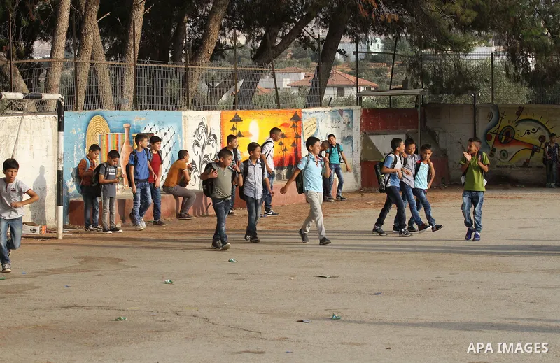 Palestinian students return back to their school in the morning of the first day of the new year study, in the West Bank city of Nablus, on August 28, 2016. Photo by Nedal Eshtayah