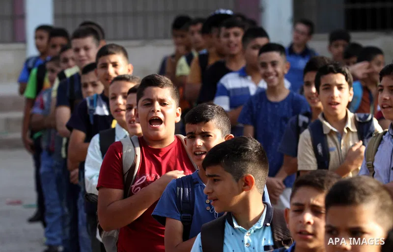 Palestinian schoolboys play exercises inside their school in the morning of the first day of the new year study, in the West Bank city of Nablus, on August 28, 2016. Photo by Nedal Eshtayah