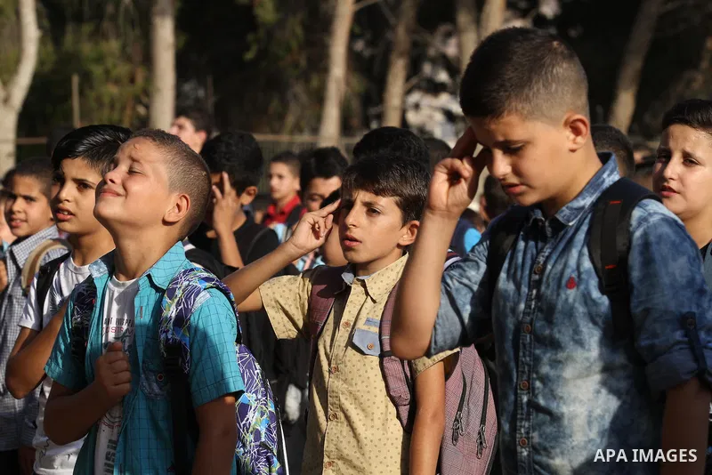 Palestinian schoolboys play exercises inside their school in the morning of the first day of the new year study, in the West Bank city of Nablus, on August 28, 2016. Photo by Nedal Eshtayah