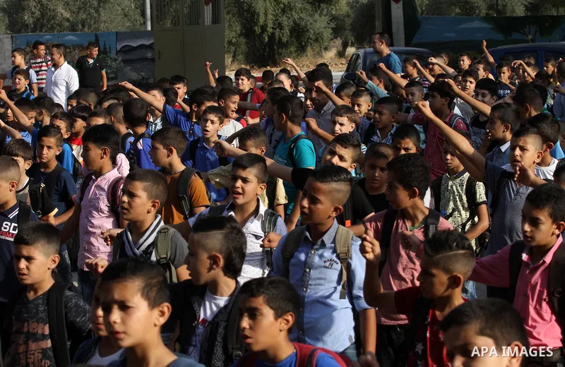 Palestinian schoolboys play exercises inside their school in the morning of the first day of the new year study, in the West Bank city of Nablus, on August 28, 2016. Photo by Nedal Eshtayah