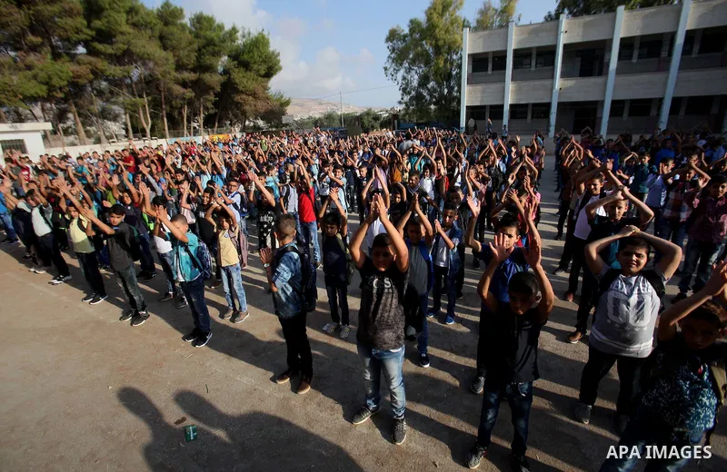 Palestinian schoolboys play exercises inside their school in the morning of the first day of the new year study, in the West Bank city of Nablus, on August 28, 2016. Photo by Nedal Eshtayah