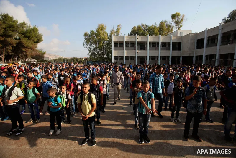 Palestinian schoolboys play exercises inside their school in the morning of the first day of the new year study, in the West Bank city of Nablus, on August 28, 2016. Photo by Nedal Eshtayah