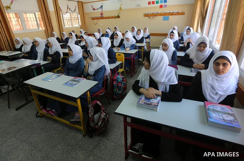 Palestinian schoolgirls attend a lesson inside a classroom, on the first day of a new school year, in Gaza city, on August 28, 2016. Photo by Mohammed Asad