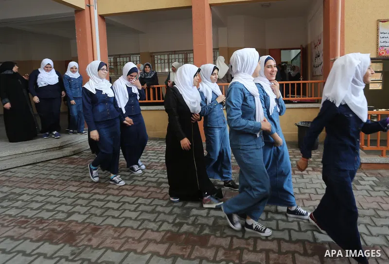 Palestinian schoolgirls return back to their school in the morning of the first day of the new year study, in Gaza city, on August 28, 2016. Photo by Mohammed Asad
