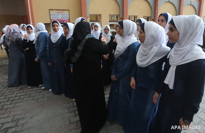 Palestinian schoolgirls return back to their school in the morning of the first day of the new year study, in Gaza city, on August 28, 2016. Photo by Mohammed Asad
